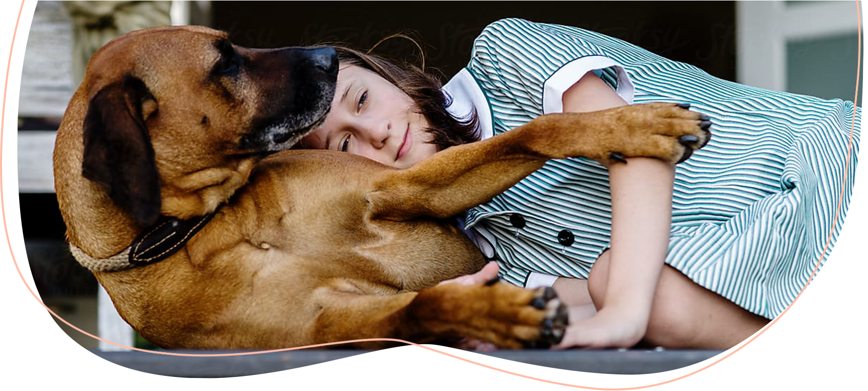 Young girl resting her head on her dog